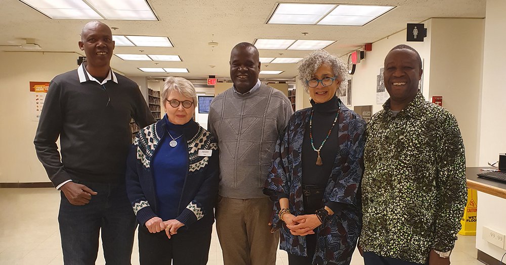 Three Kenya Archivists standing with two female SU Libraries staff